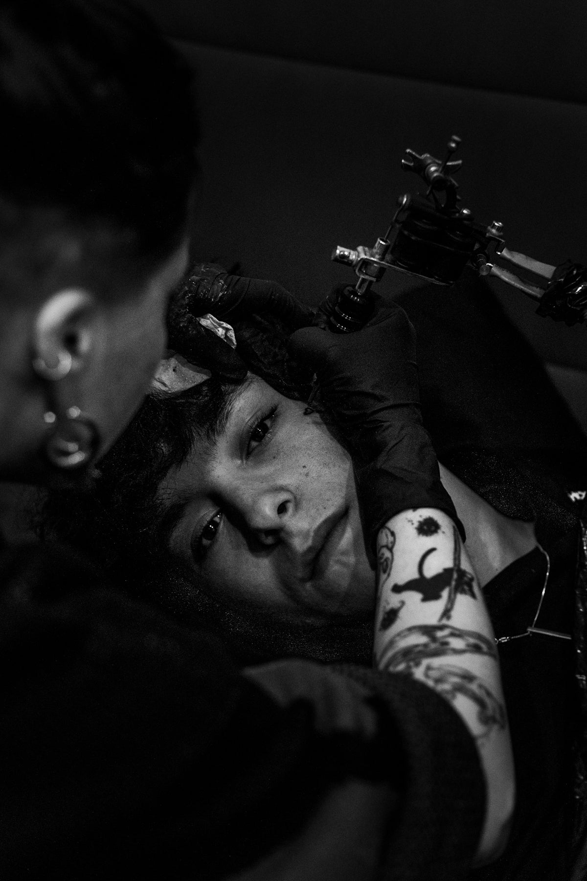 man getting a tattoo on cheek