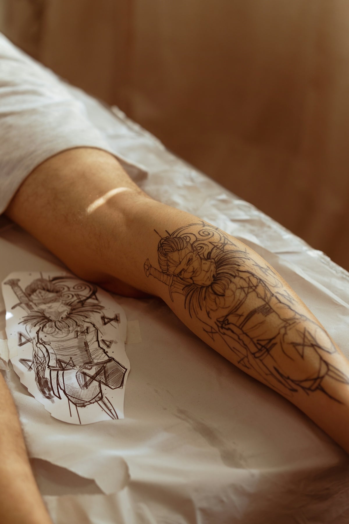 a person's arm with tattoos