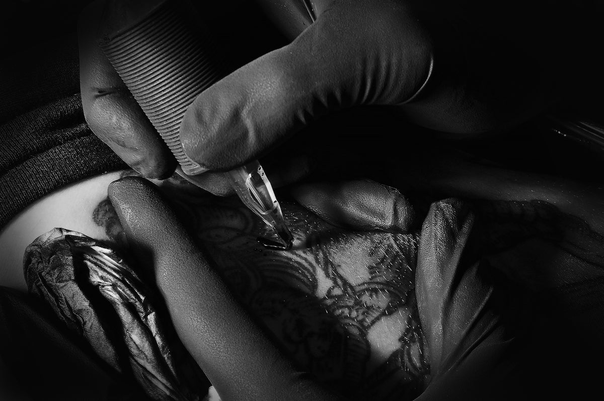 a close-up of a person holding a needle