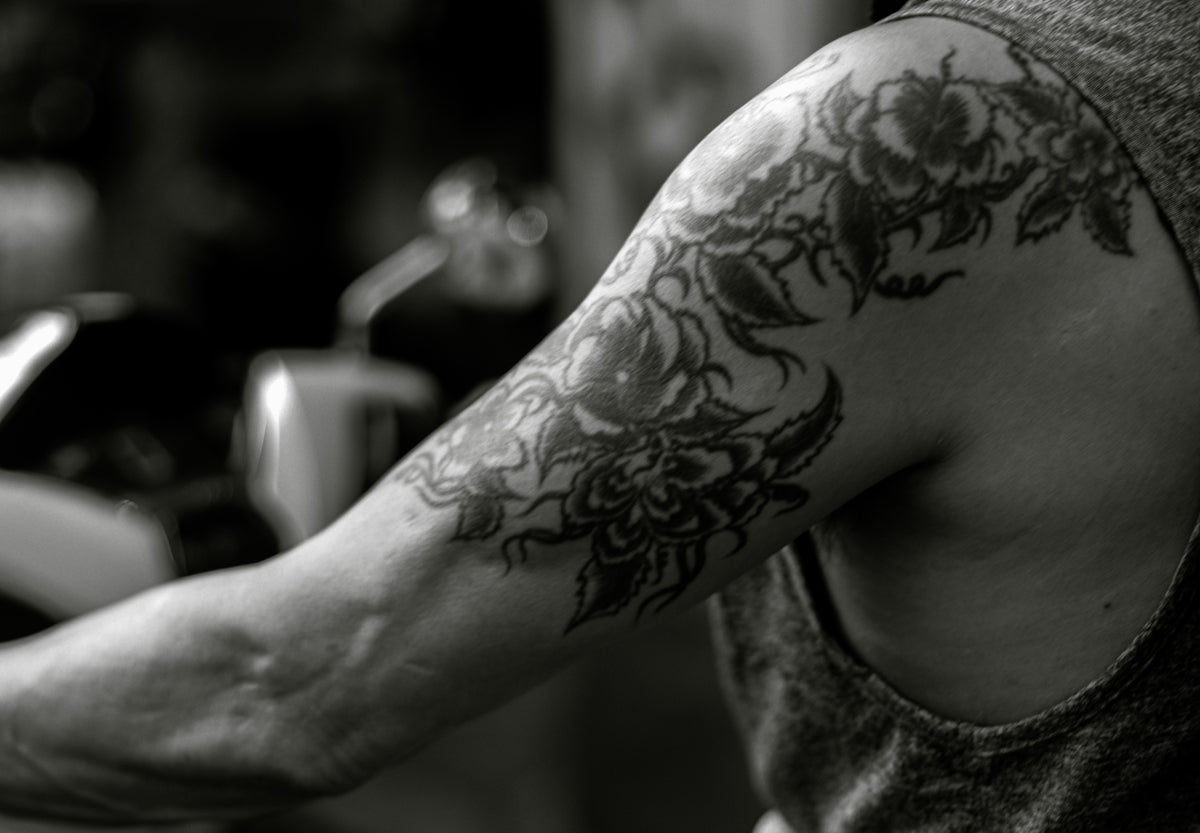 a man with a dragon tattoo on his arm