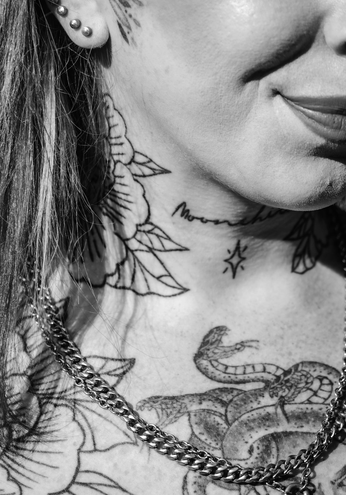 A person shows off their neck tattoos.