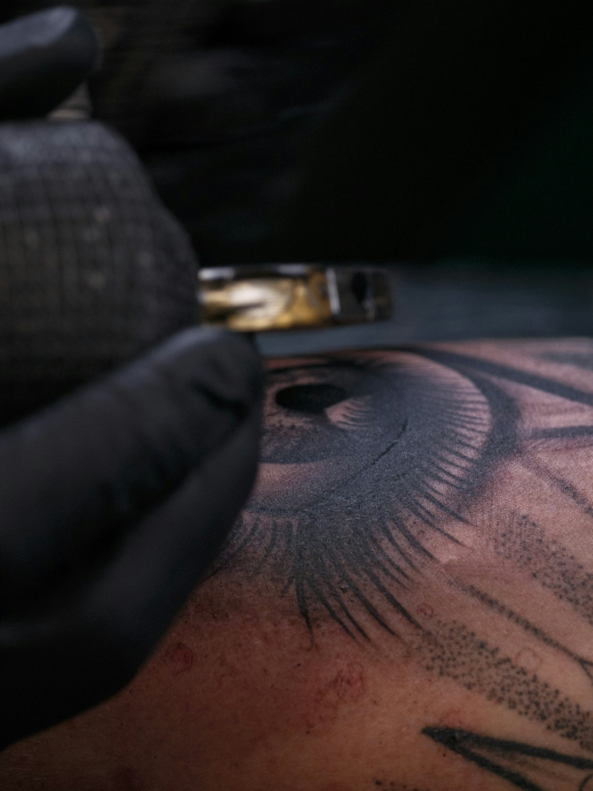 Tattoo artist working on eye design