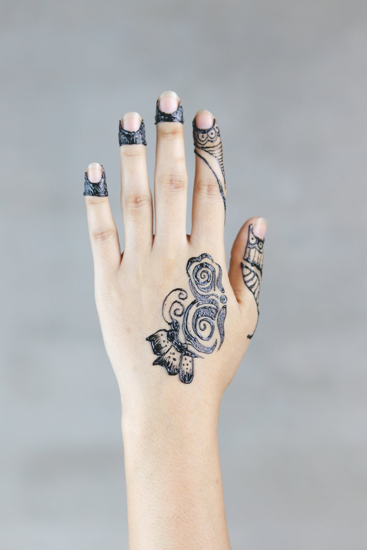 left person's hand with tattoo