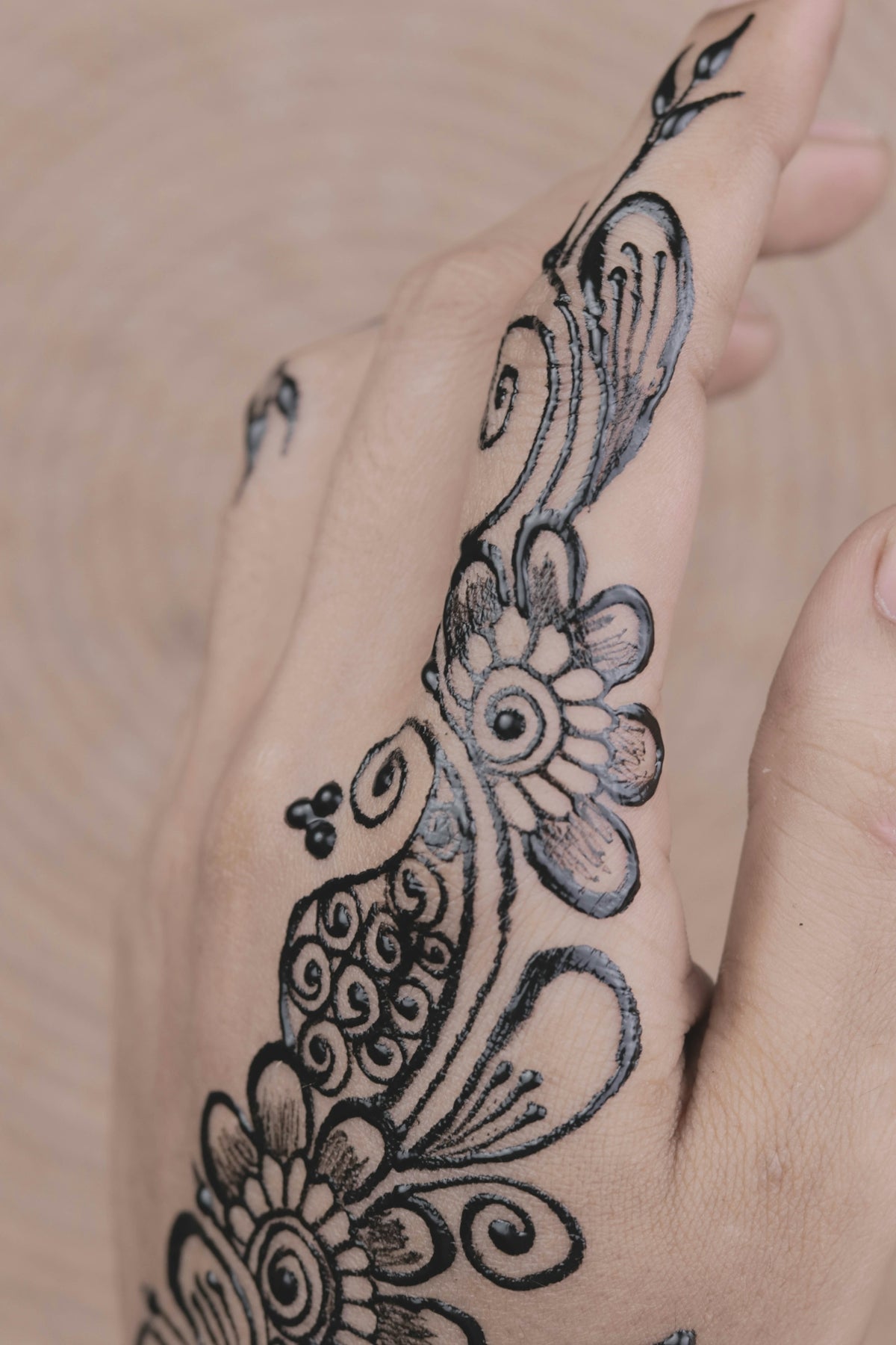 a woman's hand with a tattoo on it