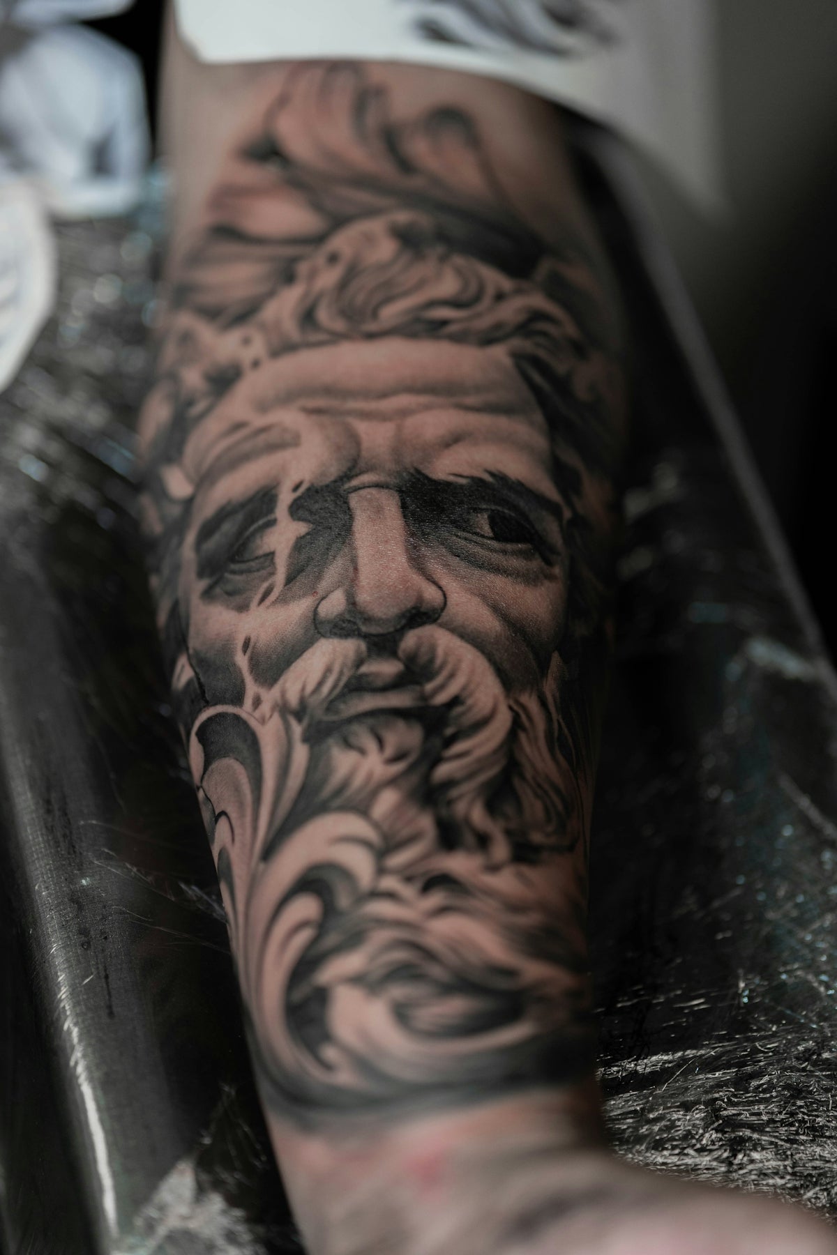 a man with a beard and a beard tattoo on his arm