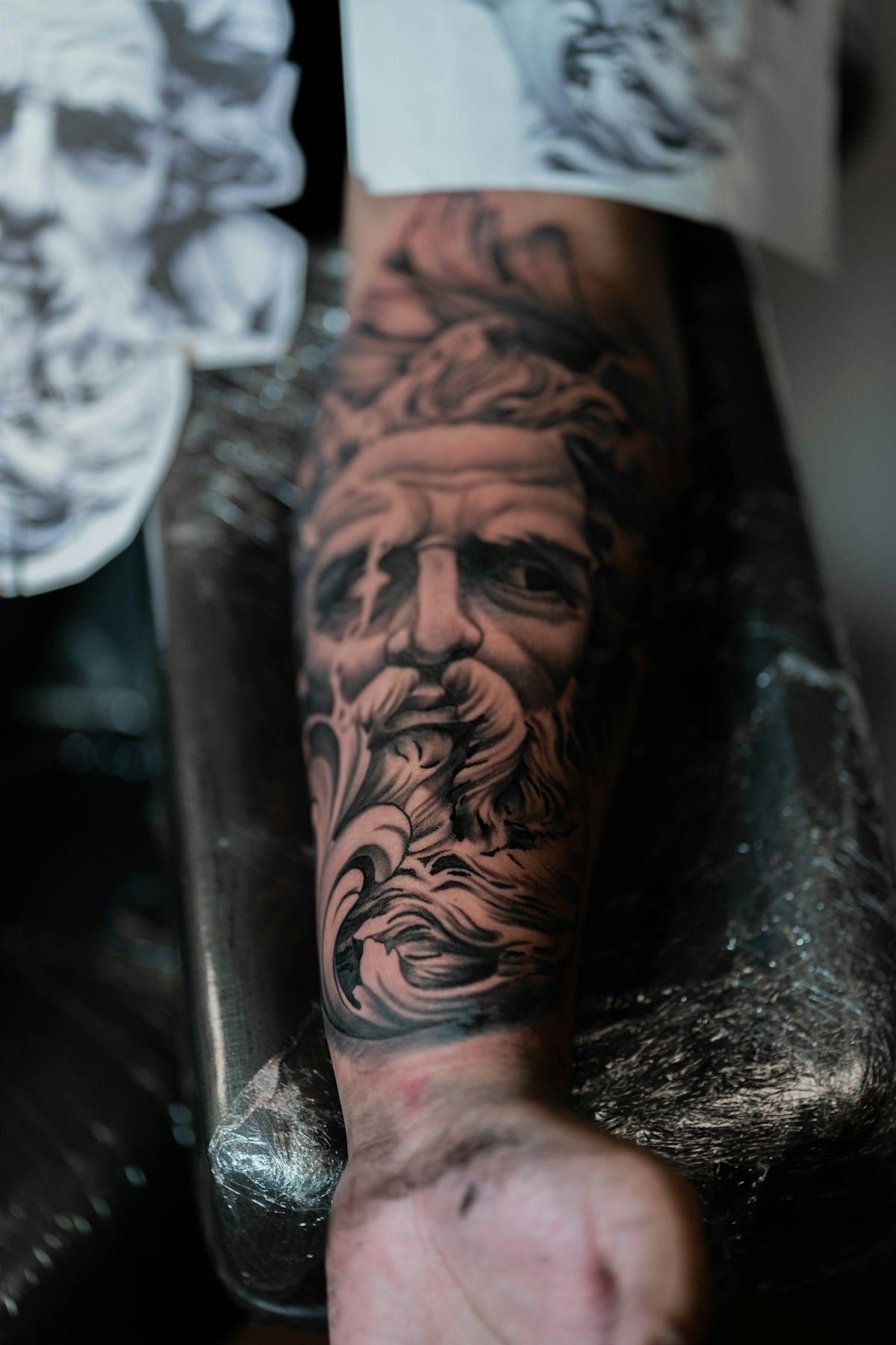 a man with a beard and a beard tattoo on his arm