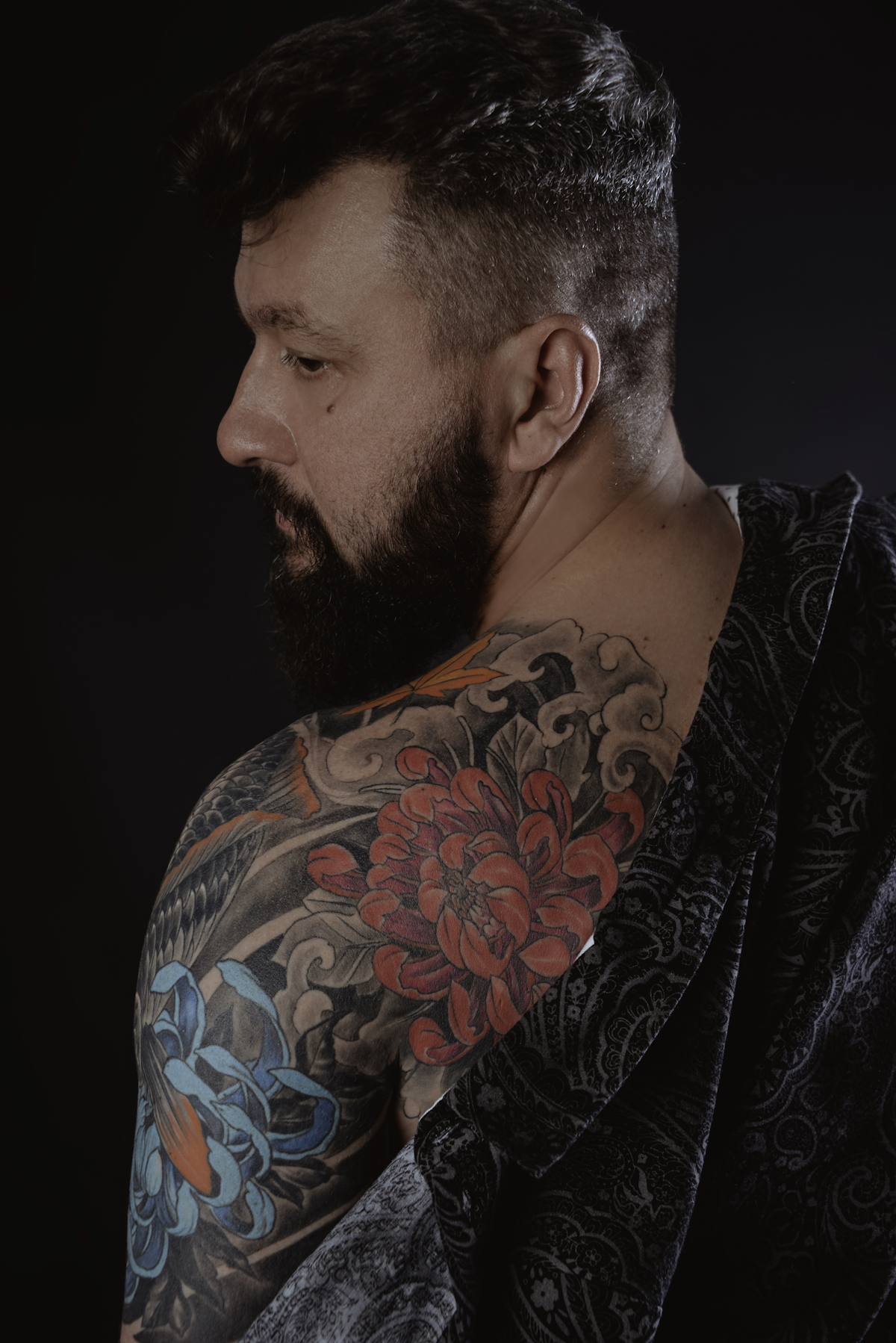 a man with a beard looking down