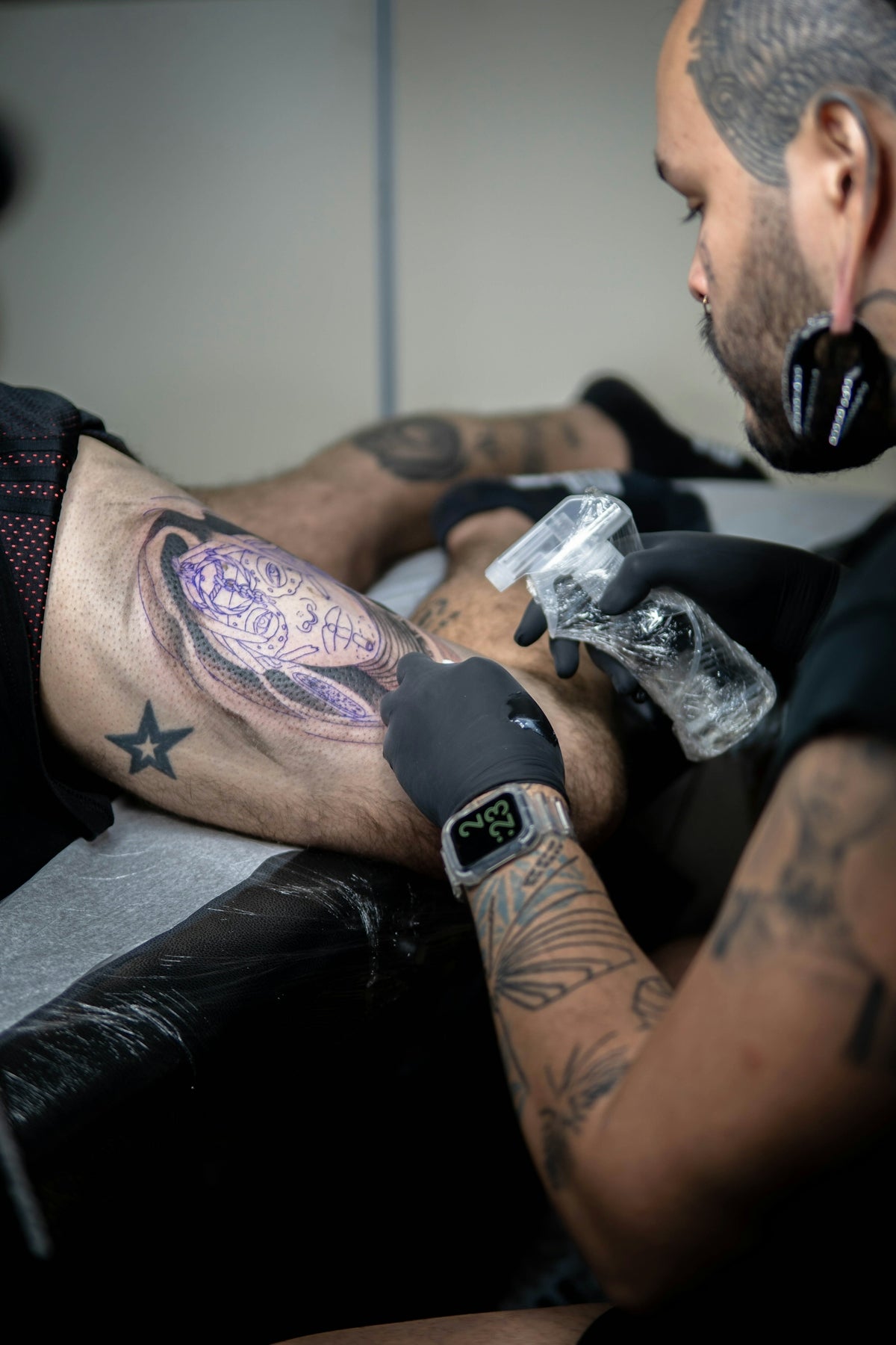 a man with tattoos holding a bird