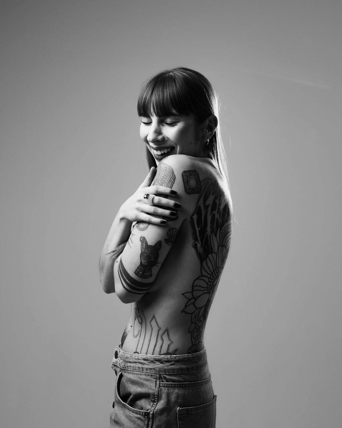 a woman with a tattooed arm holding a microphone