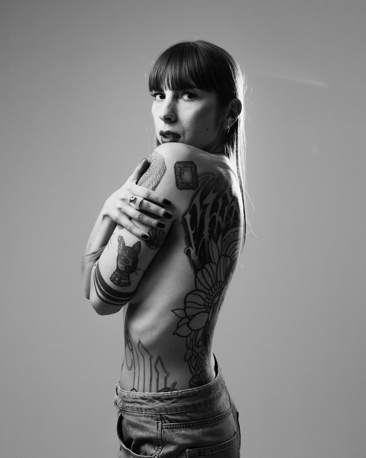 a woman with tattoos is holding a microphone