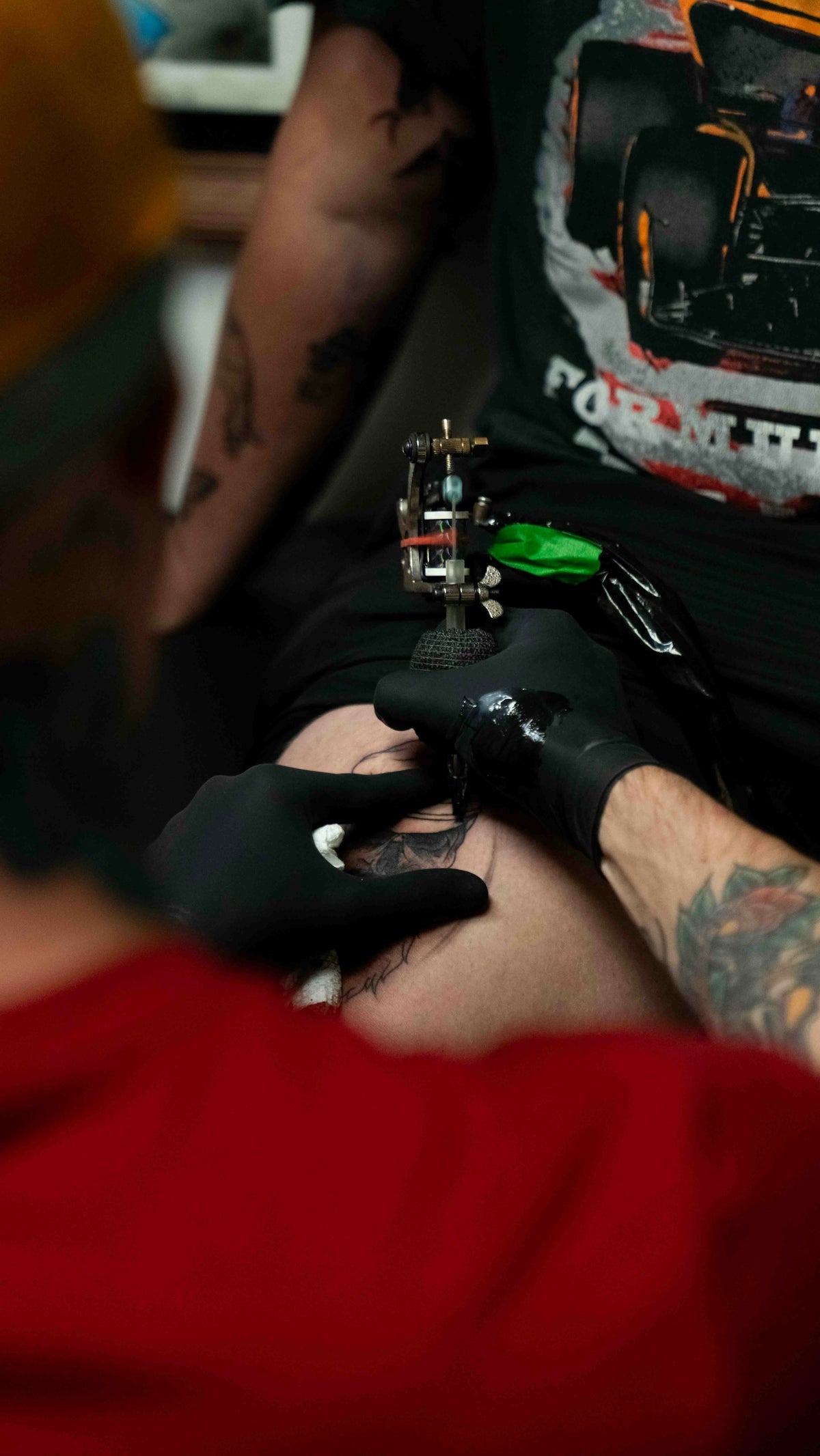 a man with a tattoo on his arm getting a tattoo