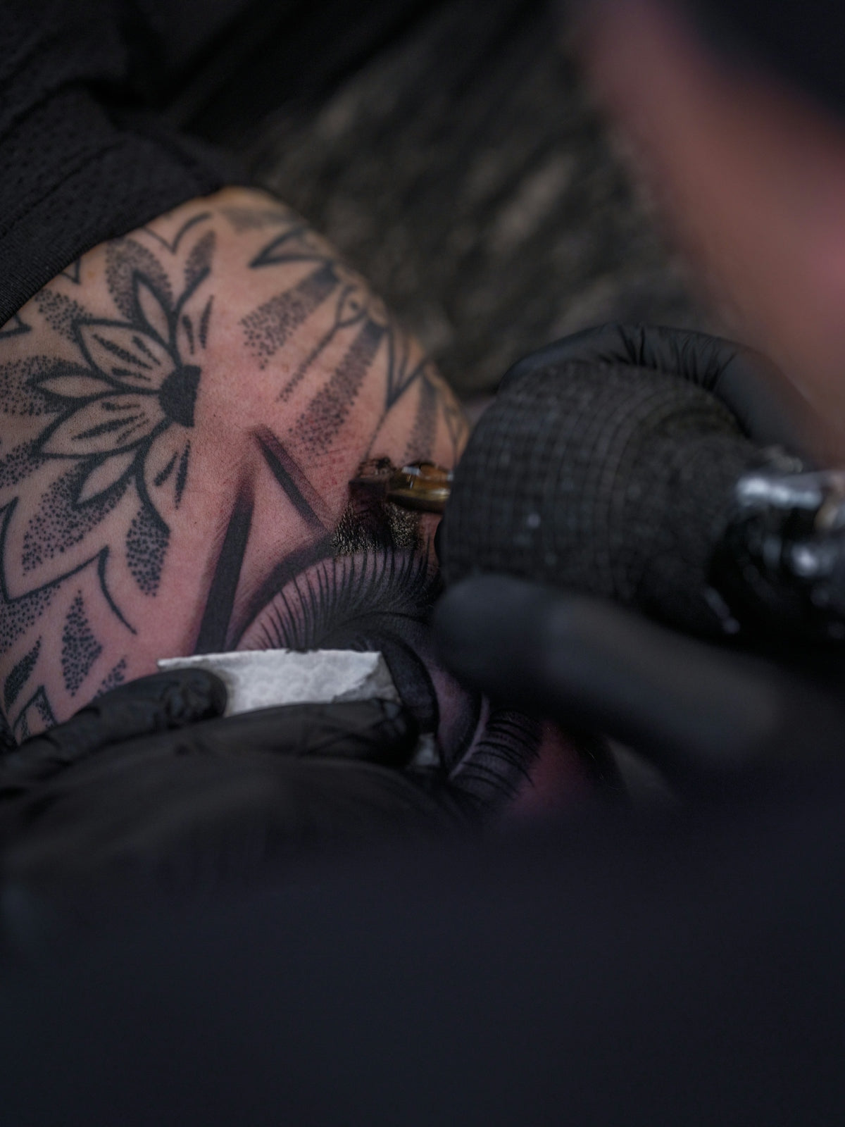 Tattoo artist working on intricate design