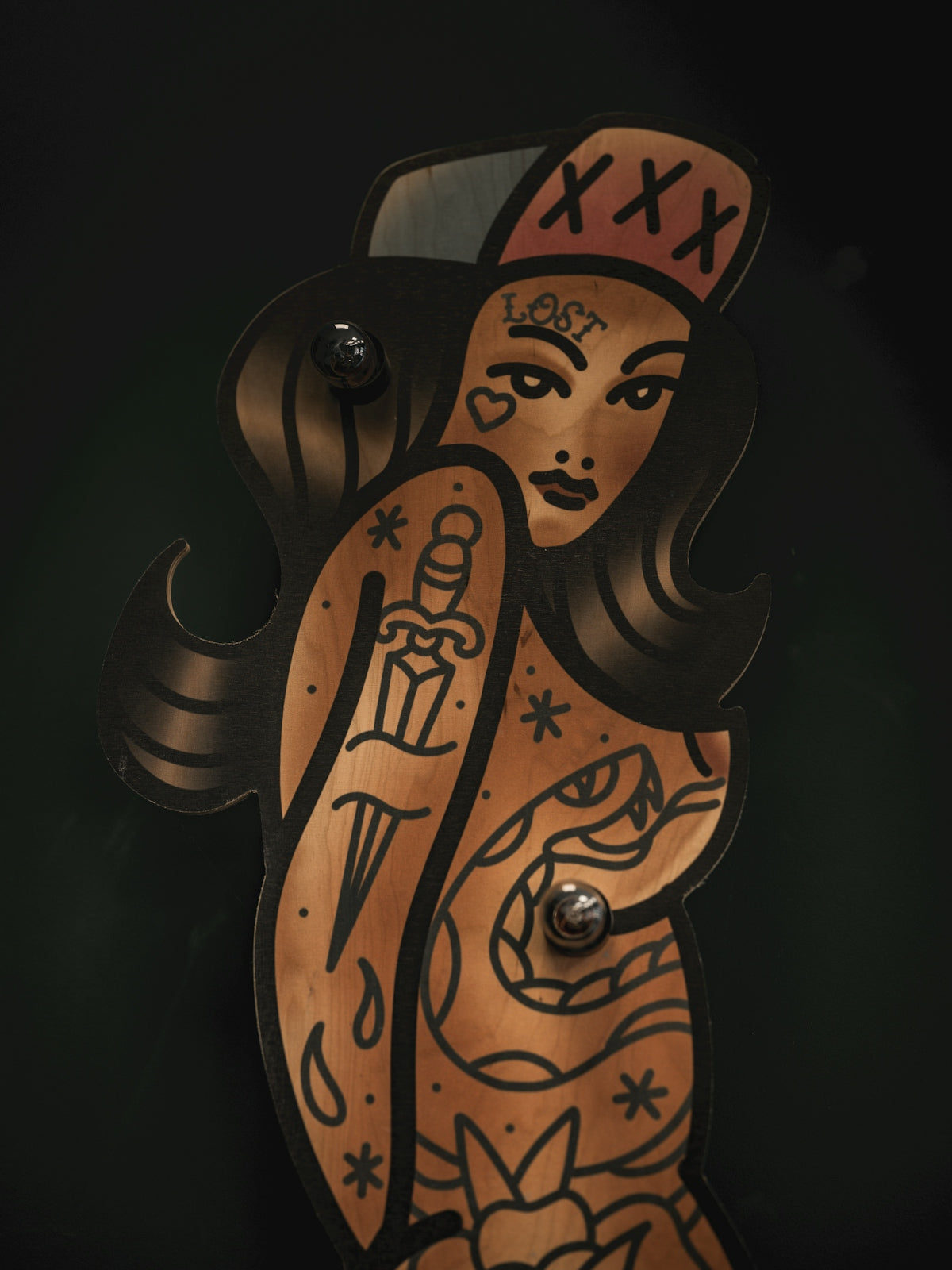 Tattoo-inspired artwork of a woman with snake and dagger.